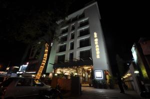 a hotel with a car parked in front of it at Le Grande Residency -Unmarried Couples are not Allowed in Ahmedabad