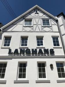 a white building with a sign on the front of it at Hotel Langhans in Abstatt
