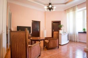 a dining room with a table and wicker chairs at Luna apartment in Novi Sad