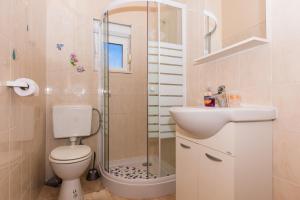 ein Badezimmer mit Dusche, Toilette und Waschbecken in der Unterkunft Apartman Anamarija in Trogir + 37 Fotos