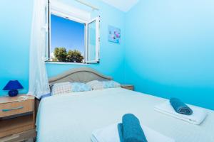 Ein Bett oder Betten in einem Zimmer der Unterkunft Apartman Anamarija