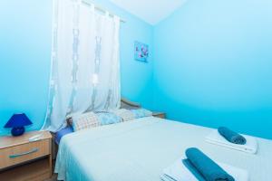 Ein Bett oder Betten in einem Zimmer der Unterkunft Apartman Anamarija