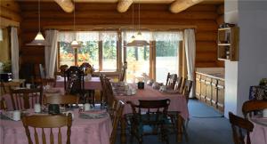 a dining room with a table with pink tables and chairs at Nakiska Ranch in Clearwater