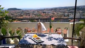 a table with a plate of food on a balcony at Le Panoramic Boutique Hôtel in Nice