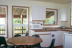 a kitchen with a table and a microwave at HI Rossburn 9 Finger Ranch in Rossburn