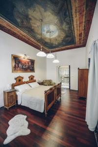 a bedroom with a bed with a painting on the ceiling at Feel Ljubljana Centre in Ljubljana