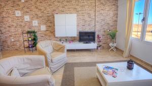 Televízia a/alebo spoločenská miestnosť v ubytovaní Edificio Prieto VIV 2C