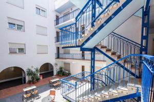 a staircase in a building with blue rails at Hotel Blason Junior in Peñíscola