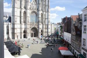 a group of people walking in front of a cathedral at HotelO Kathedral in Antwerp
