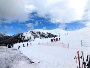 a group of people on a snow covered ski slope at Cabana Santa Matilde in Malalcahuello