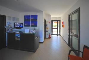 a room with a counter and a hallway with blue cabinets at Villa Faro B&B in San Vito lo Capo