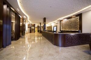 a lobby of a hotel with a reception desk at Elaf Aparthotel in Buraydah