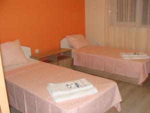 a room with two beds with towels on them at Apartments Georgos in Sofia