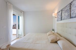 biała sypialnia z dużym łóżkiem i oknem w obiekcie weforyou Two Rooms Terramar Alto with Sea View w mieście Benalmádena +28 zdjęć