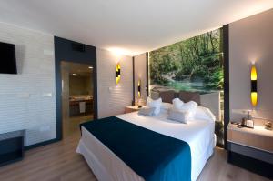 a bedroom with a large bed and a large window at Hotel La Laguna Spa & Golf in Torrevieja +73 photos