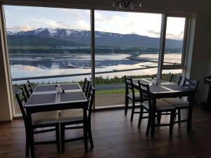 a dining room table with a view of the ocean at Hafdals Hotel in Akureyri