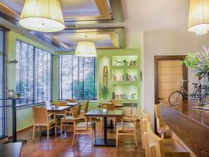 a restaurant with tables and chairs and windows at Akti Retzika in Epanomi