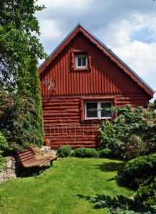 a log cabin with a bench in front of it at Kasienka Cottage in Stronie Śląskie