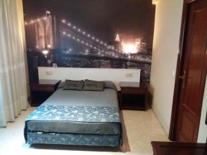 a bedroom with a bed with a view of the city at Hotel Nuevo Ara in Cáceres