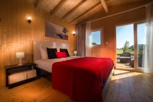 a bedroom with a large bed and a large window at Monte do Zeca in Zambujeira do Mar +97 photos