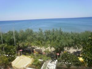 a view of the beach from the balcony of a resort at Creta Sun Apartments in Makry Gialos