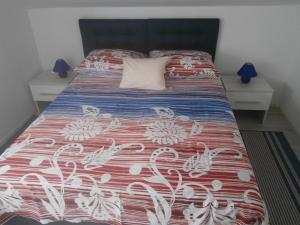 a bedroom with a bed with a red and white bedspread at Ljiljana in Srima +34 photos