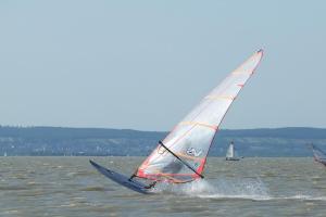 a person is windsurfing on the water with a sail at Haus Trappiste FOR FAMILIES ONLY NON SMOKING !! AIRCO ! in Donnerskirchen