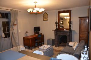 a living room with a couch and a fireplace at Studio Moncoeur in Le Blanc