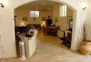 a living room with an archway and a dining room at Doreen Suites in Kalamaki