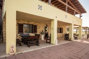an outside view of a house with a patio at Villa Gengi in Ardea
