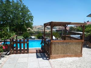 a swimming pool with a gazebo next to a swimming pool at Ca'Silvia in San Savino