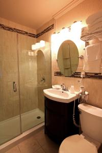 a bathroom with a sink and a shower and a toilet at Colton Court Motor Inn in Cape May