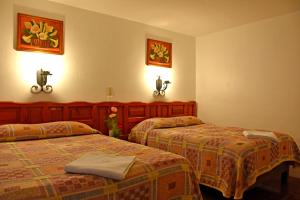 Postel nebo postele na pokoji v ubytování Hotel San Luis
