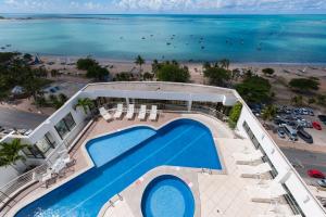 an overhead view of a swimming pool and the beach at Best Western Premier Maceió in Maceió