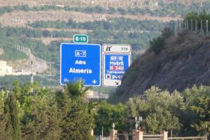 a group of signs on the side of a highway at Villa del Este in Motril