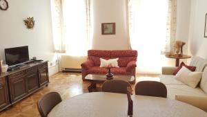 a living room with a couch and a tv at Centar old town, with parking place in Pula