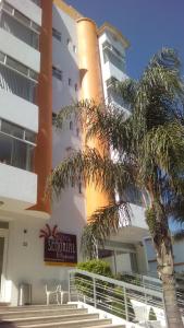 a building with a palm tree in front of it at Hotel Señorial Tlaxcala in Tlaxcala de Xicohténcatl