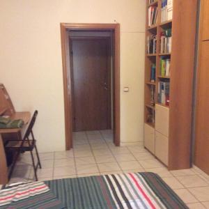 a room with a door and a book shelf at Filyra Homestay (Όμορφο δωμάτιο σε σπίτι) in Athens