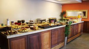 a buffet with many different types of food on a counter at Hotel Vila Nova in Teresópolis