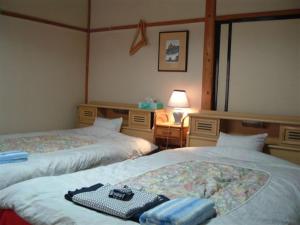 Postel nebo postele na pokoji v ubytování Onsen Inn 36So
