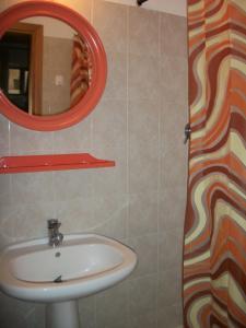 a bathroom with a sink and a mirror at Hotel Signorini in Castiglioncello