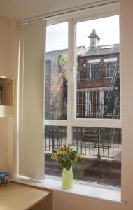a window with a view of a building at Renshaw Guest House in Liverpool
