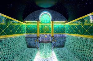 a bathroom with a blue and green tiled wall at Iris Spa in Loutra Edipsou