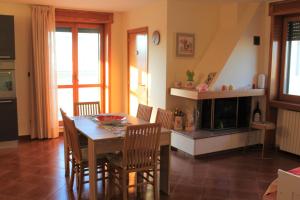 a dining room with a table and a fireplace at Mansarda Panoramica in Galatina