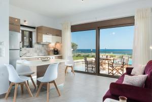 a kitchen and living room with a view of the ocean at Niovi Seaside Suites in Kissamos