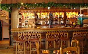 a bar with a lot of bottles of alcohol at Hôtel Les Glaciers in Samoëns