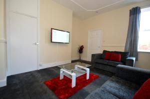 a living room with a couch and a table at Hyde Park Apartment in Gateshead
