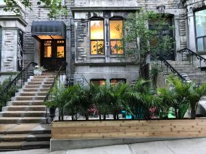 a house with palm trees in front of it at Ambrose House & Cafe - SELF CHECK-IN GUESTHOUSE in Montreal