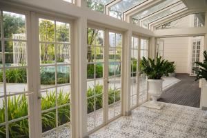 a conservatory with glass doors and a porch with a plant at 2 Bedroom Summer Huahin Condominium in Hua Hin