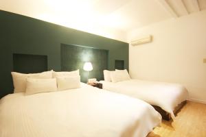 Postelja oz. postelje v sobi nastanitve Charmant Hotel